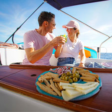 couple having a vermouth on a sailboat